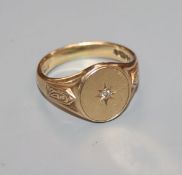 A 9ct gold and diamond gypsy-set ring with carved shoulders, size T.