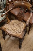 A Victorian caned mahogany desk chair