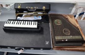 A cased Suzuki Glockenspiel, a Hohner Melodica, a cased trumpet and a Zither