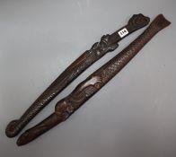 Two 19th century Japanese swords the wood scabbards, carved as a dragon and a merman longest 67cm