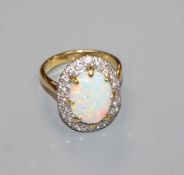 An 18ct, white opal and diamond oval cluster ring, size O.