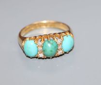 A George V 18ct gold, three stone turquoise and diamond chip set ring, size M/N.