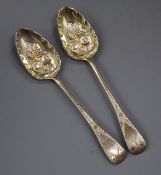 A pair of George III Old English pattern parcel silver gilt 'berry' serving spoons, London, 1806,