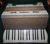 A cased Carmen piano accordion