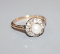 A yellow metal, cultured pearl and diamond cluster ring, size M.