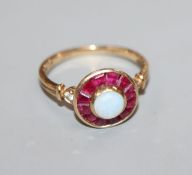 A 9ct gold, white opal and ruby cluster target ring, with diamond set shoulders, size M