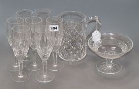 A quantity of Waterford glass including seven champagne glasses, a pedestal bowl and a jug