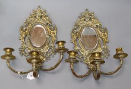 A pair of three branch mirrored wall sconces