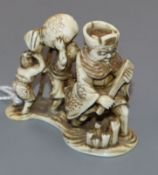 A Japanese ivory netsuke of four figures crossing the river