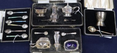 A set of six enamelled silver coffee spoons, an egg cup and spoon Christening set and two