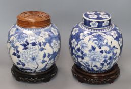 Two Chinese blue and white jars and covers and a pair of hardwood stands