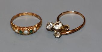 A Victorian 15ct gold, emerald and split pearl five stone half hoop ring and a three stone diamond