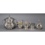 A late Victorian silver cream jug, a silver two handled porringer and three silver condiments.