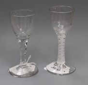 An 18th century wine glass with opaque double-twist stem and moulded funnel bowl and a similar glass