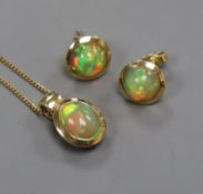 A modern 14ct gold and opal pendant necklace and a pair of matching ear studs.