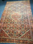 An Isphapan red and blue ground medallion rug 205 x 132cm