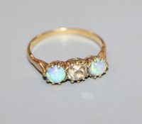 A yellow metal, white opal and diamond set three stone ring, size O.