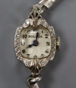 A lady's 14k white metal and diamond set Bulova manual wind cocktail watch.