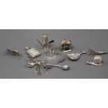 A Victorian silver caddy spoon, a similar silver miniature 'chocolate pot' pepperette and teapot and