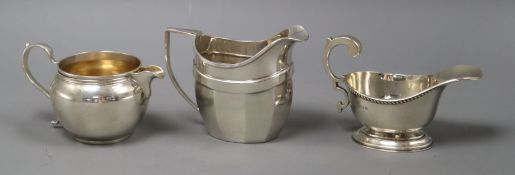 Three assorted George V silver cream jugs, 11 oz.
