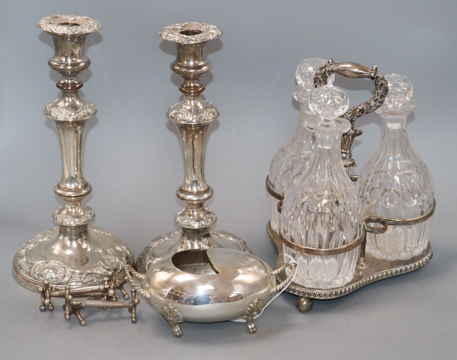A quantity of plated wares including a pair of candlesticks