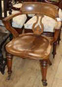 A Victorian oak and elm desk chair