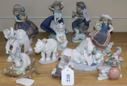 A collection of ten Lladro figures and one Nao figure, including three elephants with flowers,