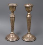 A pair of 1970's silver candlesticks, (a.f.), weighted, 21cm.