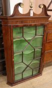 A Georgian style mahogany glazed hanging corner cupboard W.78cm