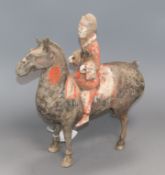 A Chinese painted pottery funerary equestrian figure, believed to be Western Han Dynasty, tail and