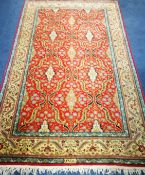 A Persian cream and red ground rug 220 x 132cm