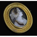 A Victorian gold mounted sardonyx oval cameo brooch, carved with the bust of a lady to sinister,