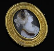 A Victorian gold mounted sardonyx oval cameo brooch, carved with the bust of a lady to sinister,