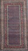 A Saraband blue ground rug, with central field of stylised pears and a six row border, 6ft 2in by