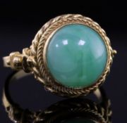 An early-mid 20th century 18ct gold and cabochon jadeite set dress ring with ropetwist border and