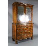 An early 18th century figured and burr walnut cabinet on chest, with moulded cornice and two