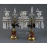 A pair of French Empire style gilt bronze and ormolu candelabra, with cut glass spires and sconces