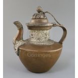 A Tibetan copper and silver teapot, 19th century, the silver boards embossed with the eight Buddhist