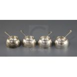 A set of four early George I Britannia standard silver circular salts by James Goodwin, with