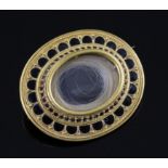 A Victorian gold and black enamel oval mourning brooch, with hair beneath a glazed panel and