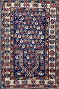 A Caucasian blue ground prayer rug, the central mihrab with field of geometric motifs and three