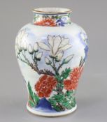 A Chinese wucai vase baluster jar, 17th century, painted with a bird in flight amid rockwork peonies