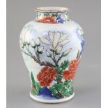 A Chinese wucai vase baluster jar, 17th century, painted with a bird in flight amid rockwork peonies