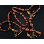 A Persian gilt metal and graduated amber bead tassel drop necklace, gross weight 198 grams, 180cm