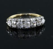 An early 20th century gold and graduated old cut diamond seven stone diamond half hoop ring, size