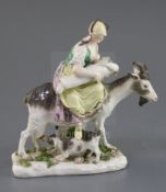 A Meissen group of the Tailor's wife, c.1750, the wife seated on a goat with suckling kid and