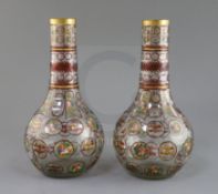 A pair of Bohemian Ottoman Market glass bottle vases, late 19th century, each enamelled and ruby