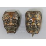 Two Japanese bronze models of noh masks, 19th century, cast as Shoki and an oni, H. 5.5 and 4.7cm