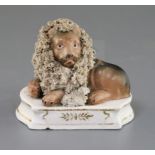 A Lloyd Shelton porcelain group of a lion and a lamb, c.1840, both recumbent on a shaped plinth with