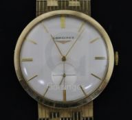 A gentleman's early 1960's 9ct gold Longines manual wind wrist watch, on a 9ct gold Longines